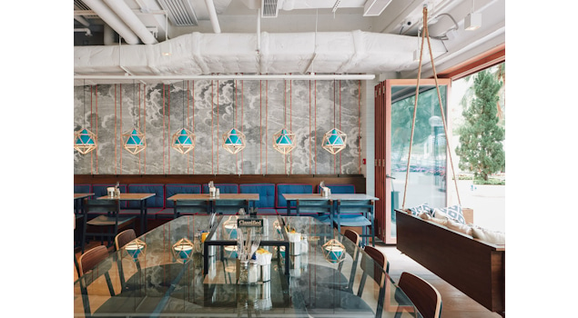 Classified Hong Kong is more than a dining experience; it's an architectural masterpiece that engages all the senses. Our inspiration drew from the café's coastal surroundings, translating into an architectural marvel that embraces marine-blue tiles, rustic timber flooring, and bespoke lobster-pot-inspired ceiling lights. Design by Studio Königshausen.